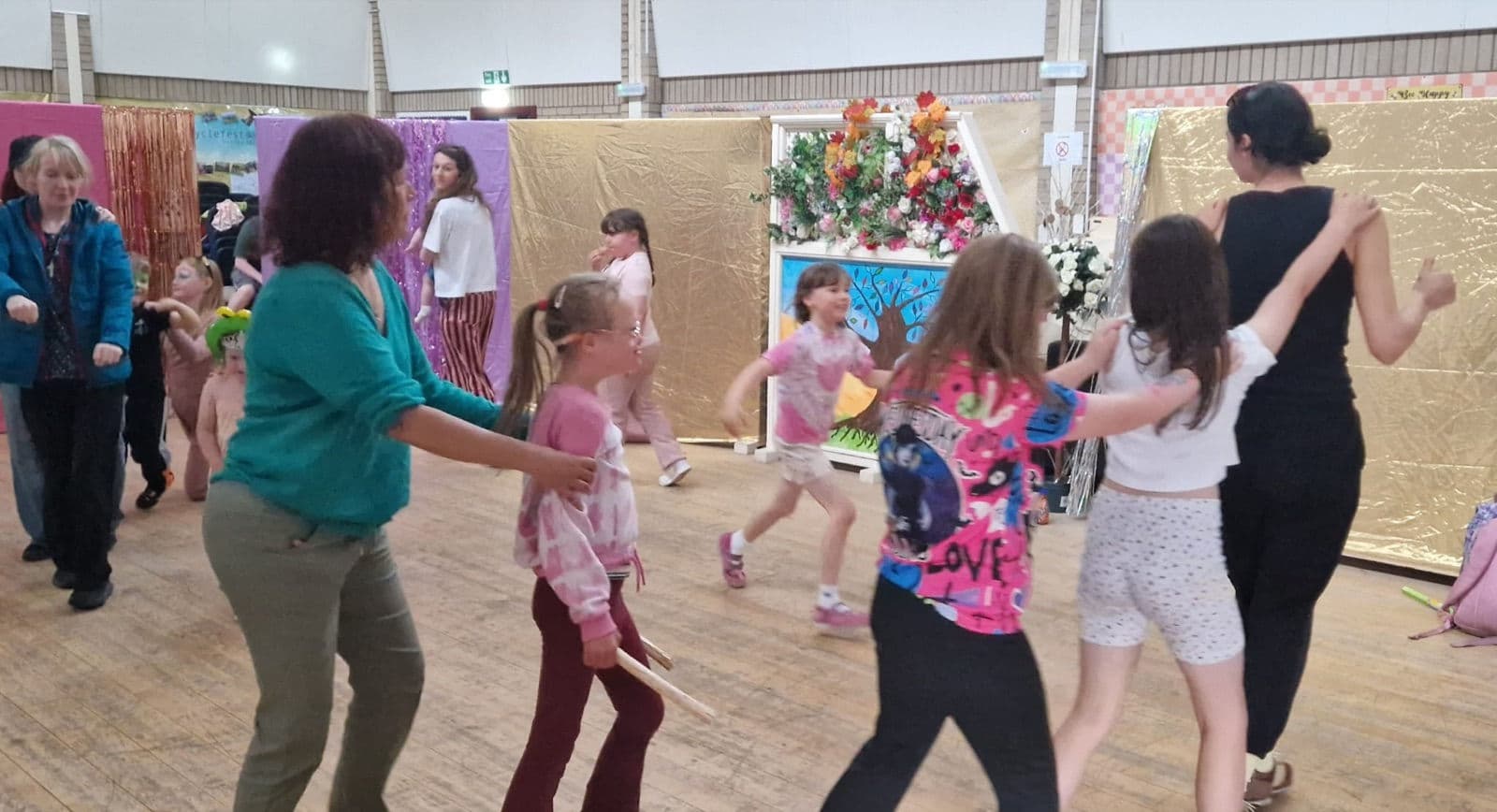 A long conga line of families snaking around the room.