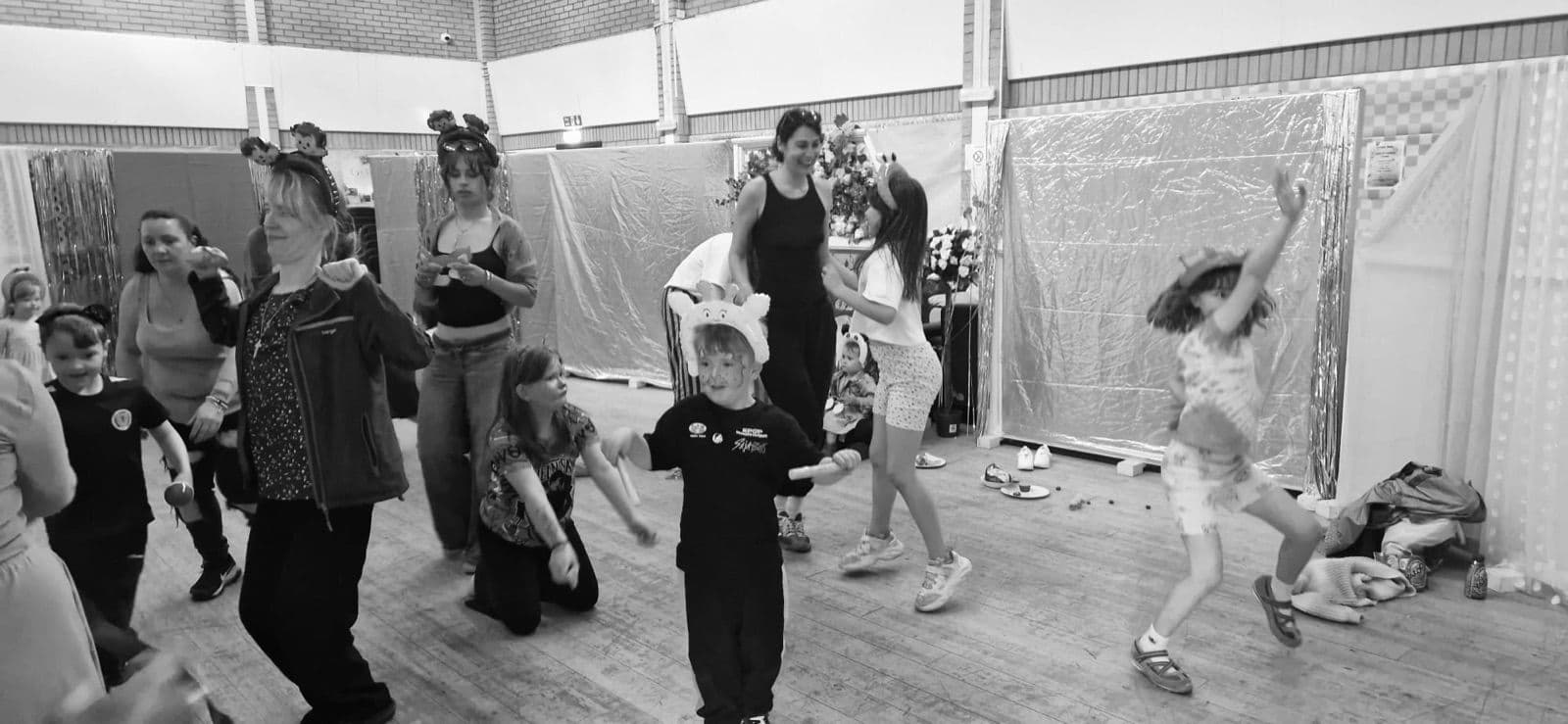 Families dancing together, in black and white.
