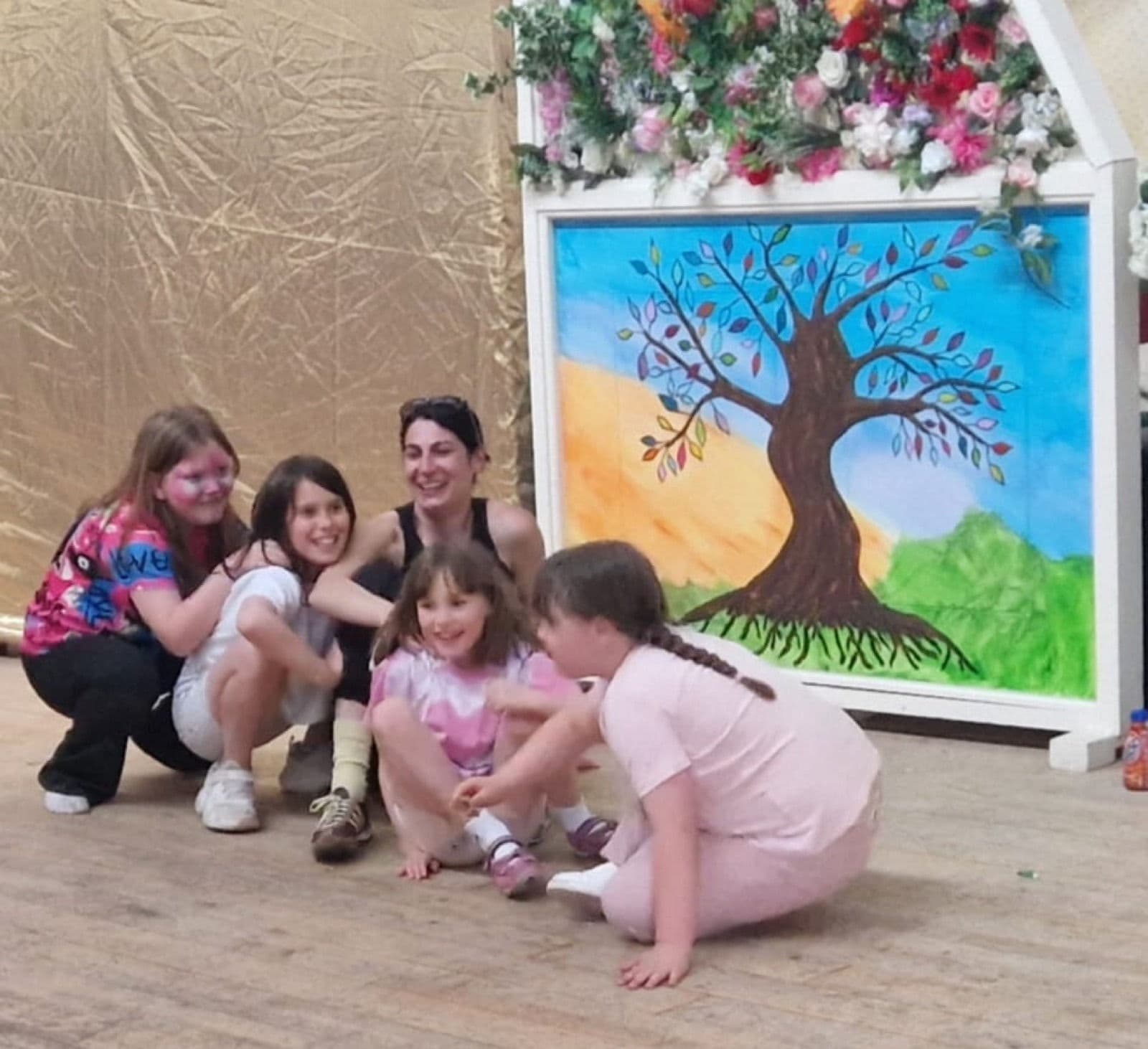A painted tree backdrop that families added to through the afternoon.